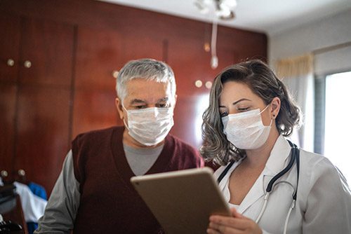 Doctor and patient reviewing tablet together.